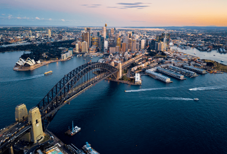 A picturesque view of Sydney Harbor and the Harbor Bridge from above