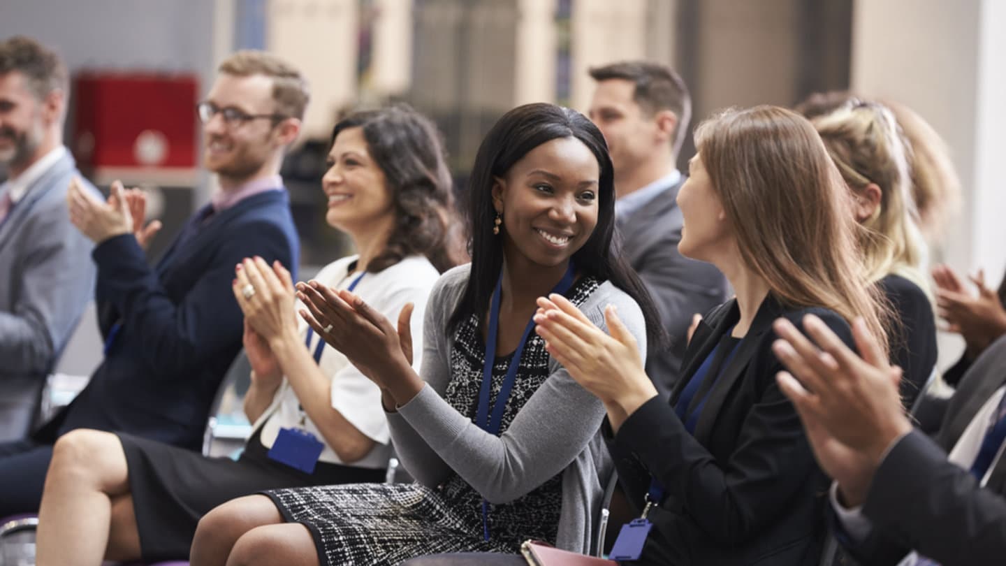 You people at a business conference watching a speech