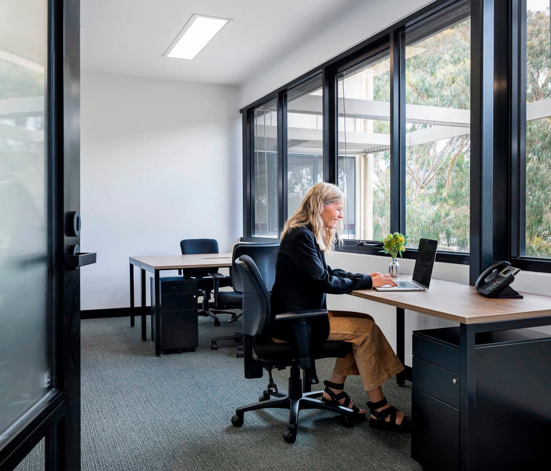 View into coworking area with shared desk spaces at 27 Baines Crescent, Torquay
