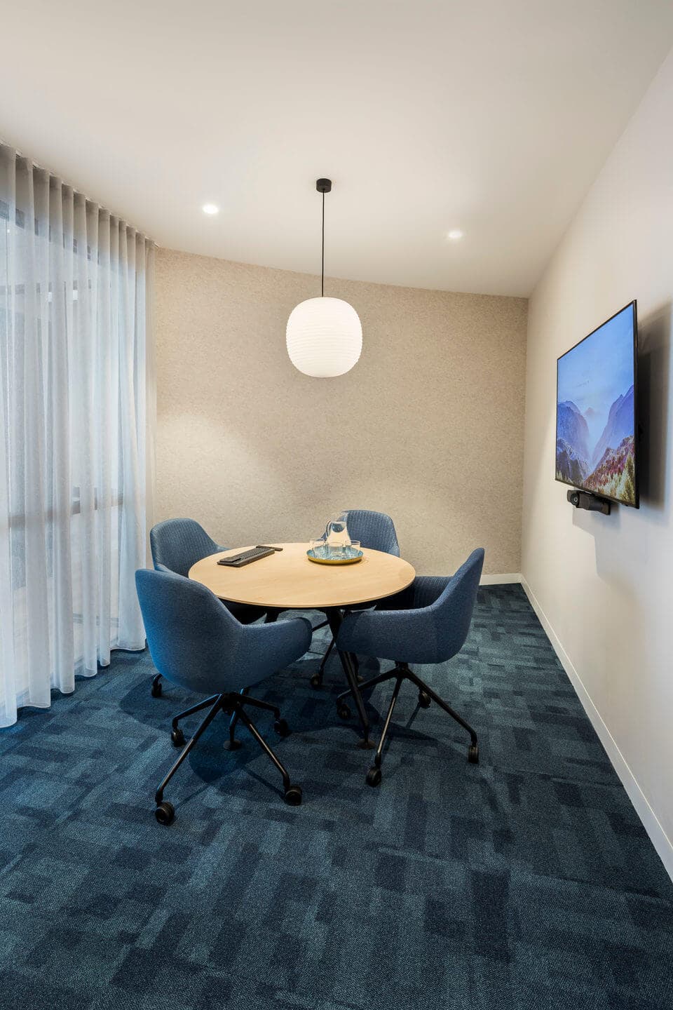 Small 4 person meeting room with video conferencing available.